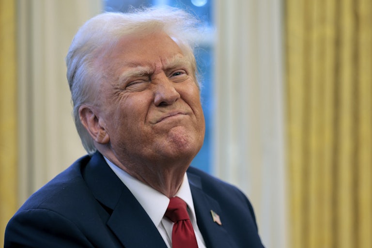 Donald Trump frowns while speaking to reporters in the Oval Office