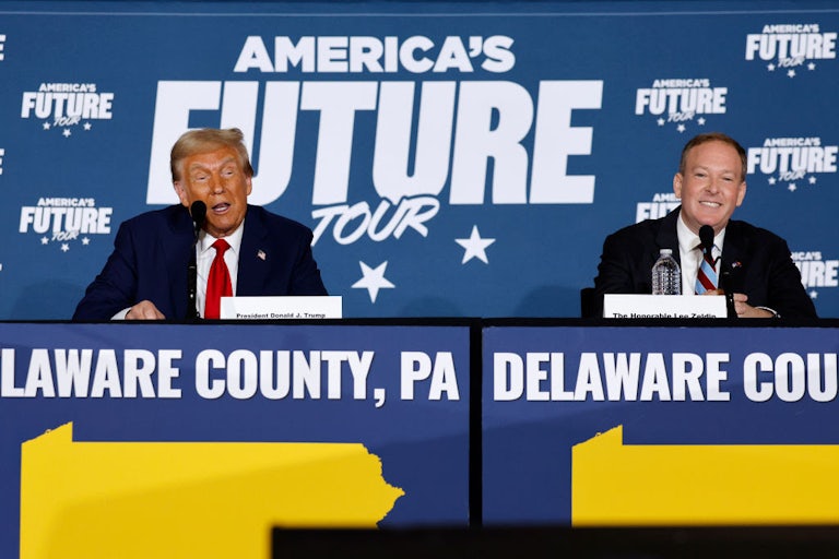 Trump and Zeldin sit in front of a banner reading "America's Future Tour."
