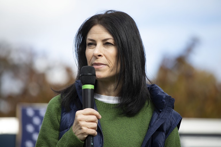 Michigan Attorney General Dana Nessel speaks outside with a microphone in hand