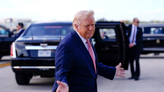 President Trump splays his hands out as if to shrug.