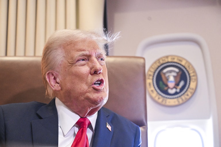 Donald Trump speaks to reporters on Air Force One