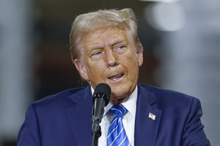 Donald Trump licks his lips and glares at something off camera