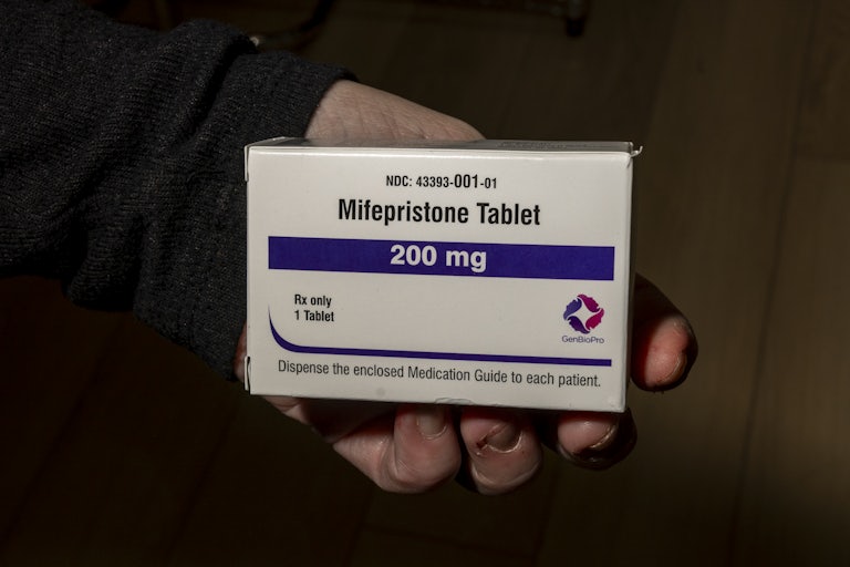 A person holds a box of mifepristone