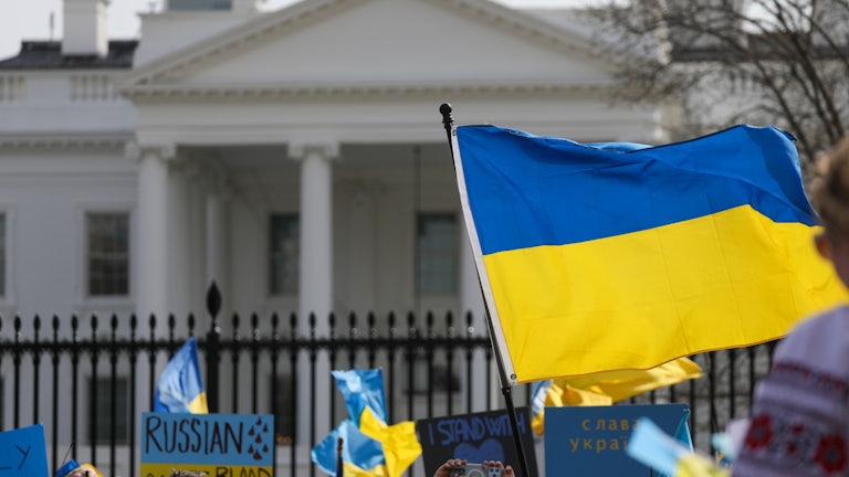 The Ukraine flag waves in front of the White House during a demonstration against the invasion.