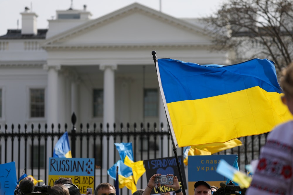 The Ukraine flag waves in front of the White House during a demonstration against the invasion.
