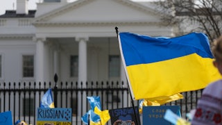 The Ukraine flag waves in front of the White House during a demonstration against the invasion.