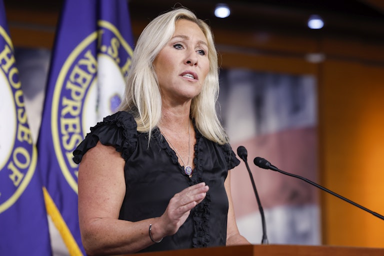 Republican Congresswoman Marjorie Taylor Greene speaks at a podium