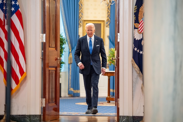 Joe Biden exits a room in the White House