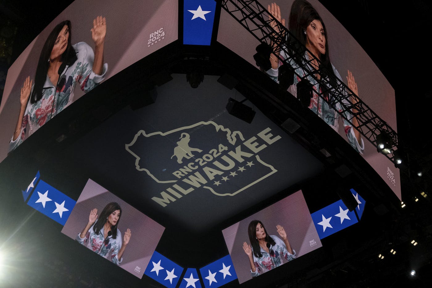 A photograph of Nikki Haley on four giant screens on the ceiling of the Republication National Convention 