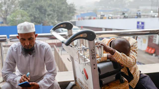 People wait outside the terminal of Hazrat Shahjalal International Airport in Dhaka, Bangladesh