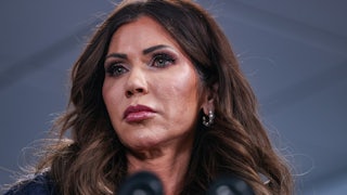 Homeland Secretary Kristi Noem stands at a microphone