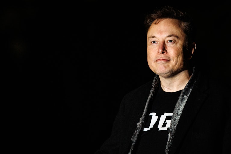 Elon Musk wears a DOGE t-shirt.