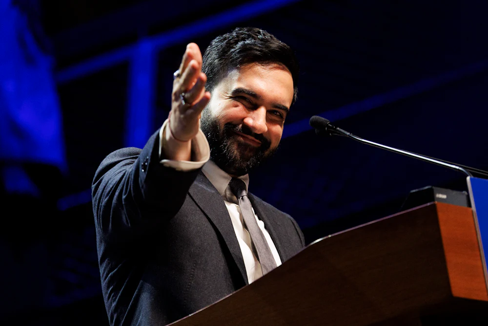 New York City Mayor Zohran Mamdani gestures, smiling, during a rally on April 12.