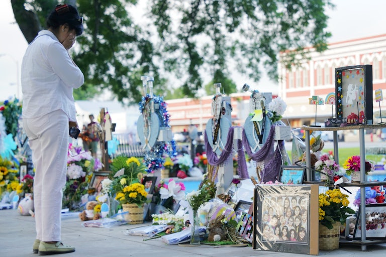 A woman mourns for victims of a school mass shooting at a square in Uvalde, Texas.