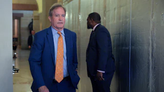 Texas Attorney General Ken Paxton walks in the Capitol