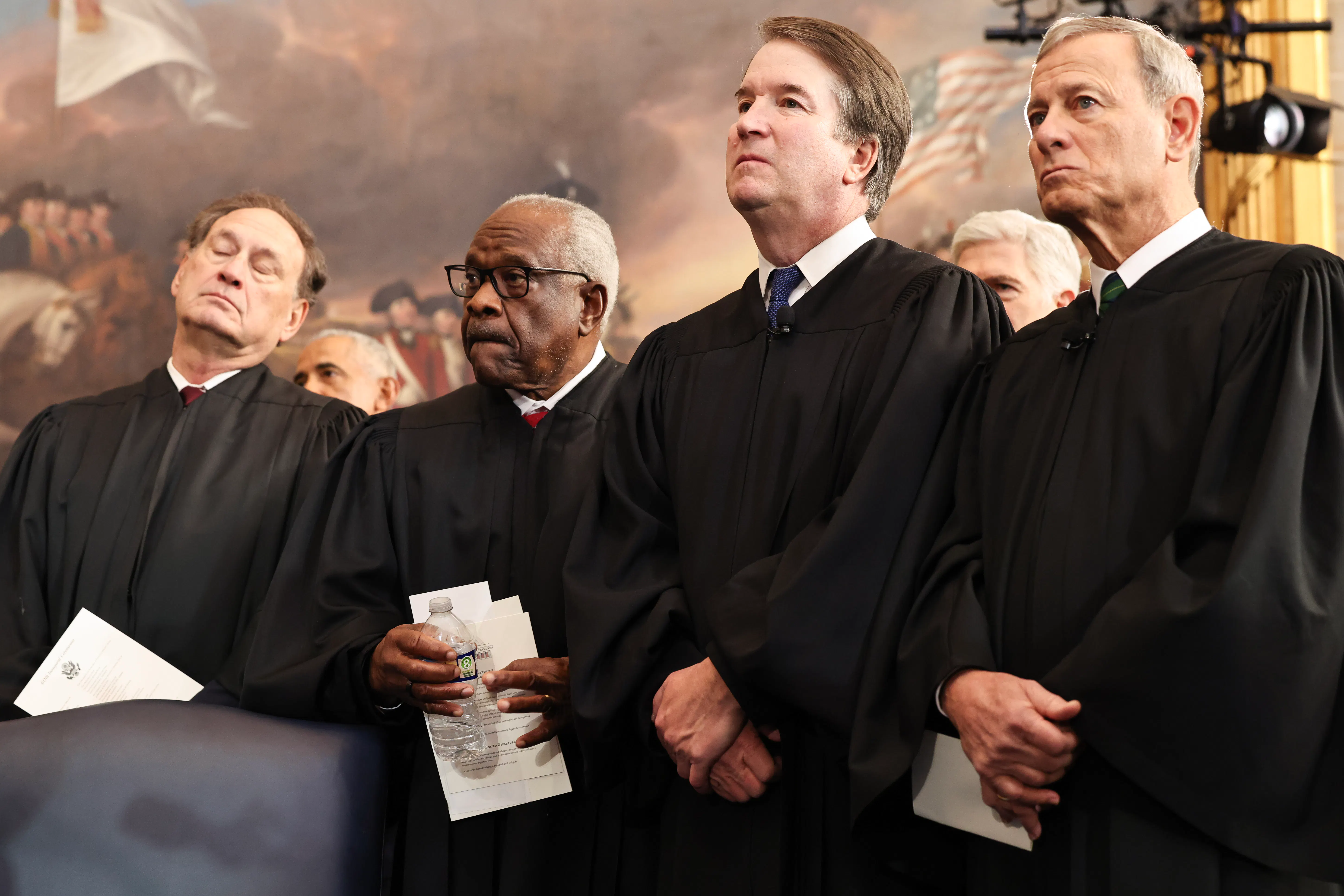 Supreme Court Justices Samuel Alito, Jr., Clarence Thomas and Brett Kavanaugh and U.S. Supreme Court Chief Justice John Roberts look on during inauguration ceremonies in the Rotunda of the U.S. Capitol.