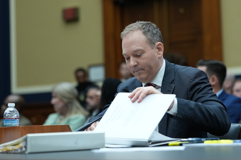 EPA Administrator Lee Zeldin looks through some papers on the table as he testifies in Congress.