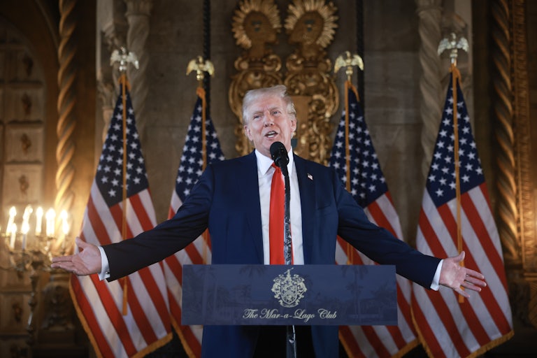Donald Trump holds his arms out while speaking during a press conference at Mar-a-Lago