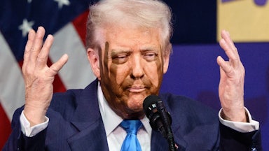 Donald Trump purses his lips and raises his hands next to his face