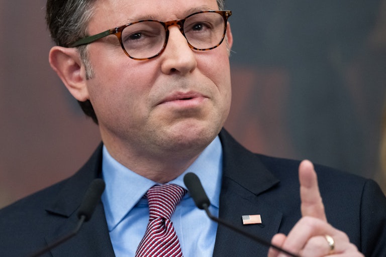 House Speaker Mike Johnson raises his finger and speaks during a press conference