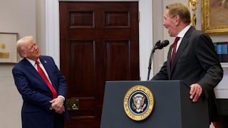 Larry Ellison leans back and smiles as he looks at Trump while speaking at the White House