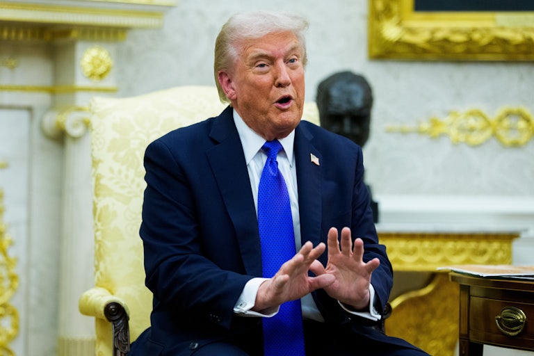 Donald Trump speaks and gestures while sitting in the Oval Office