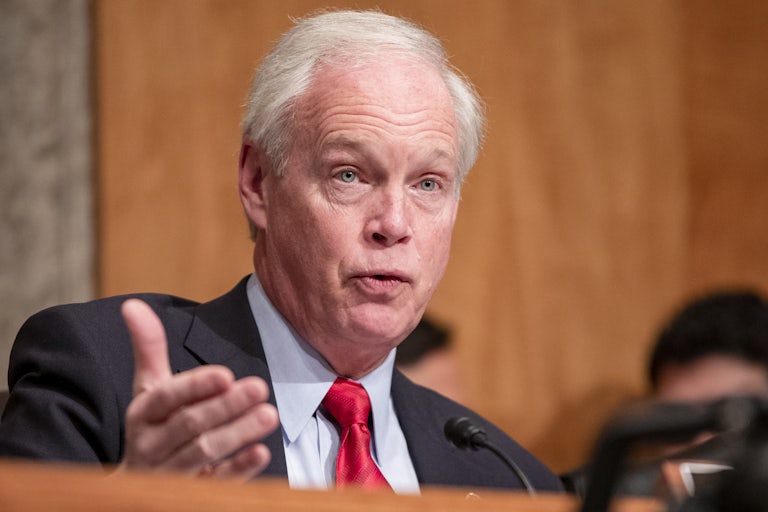 Senator Ron Johnson speaks and makes a hand gesture during a congressional hearing.