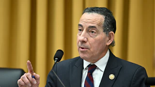 Representative Jamie Raskin holds right finger in air while speaking