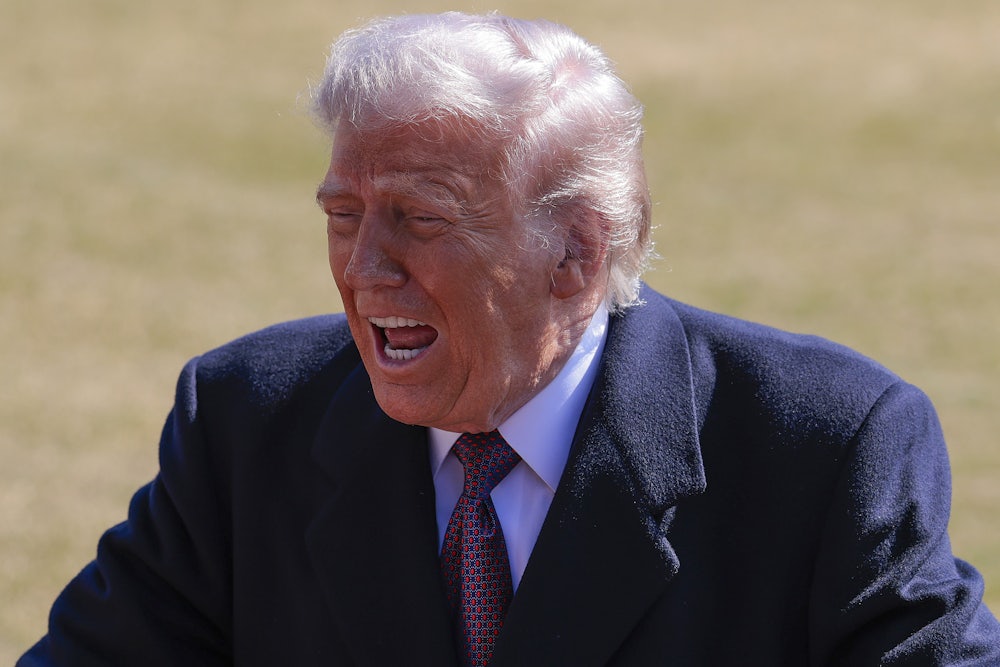 Donald Trump stands and speaks vehemently