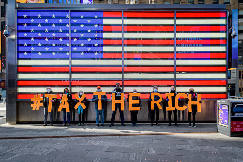 Participants seen spelling out #TaxTheRich at Times Square.