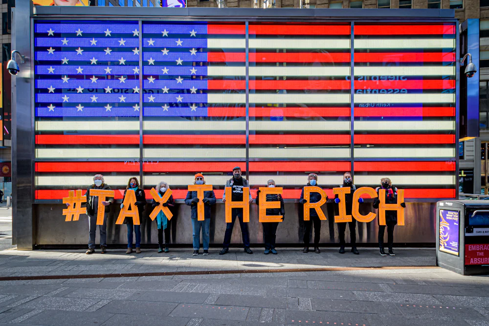 Participants seen spelling out #TaxTheRich at Times Square.