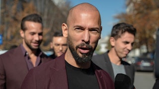 Andrew Tate speaks to reporters.