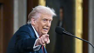 Donald Trump speaking at a lectern