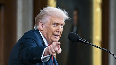 Donald Trump speaking at a lectern