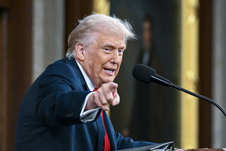 Donald Trump speaking at a lectern