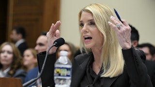 Attorney General Pam Bondi raises her hands in exasperation as she testifies in a House hearing.
