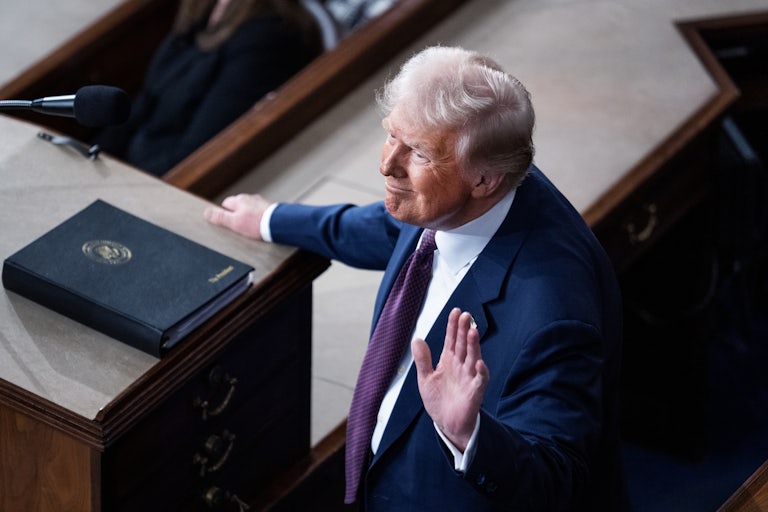 Donald Trump waves while standing in Congress after giving a speech to a joint session