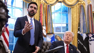 Zohran Mamdani gestures and speaks while standing next to Donald Trump, who sits at his desk in the Oval Office