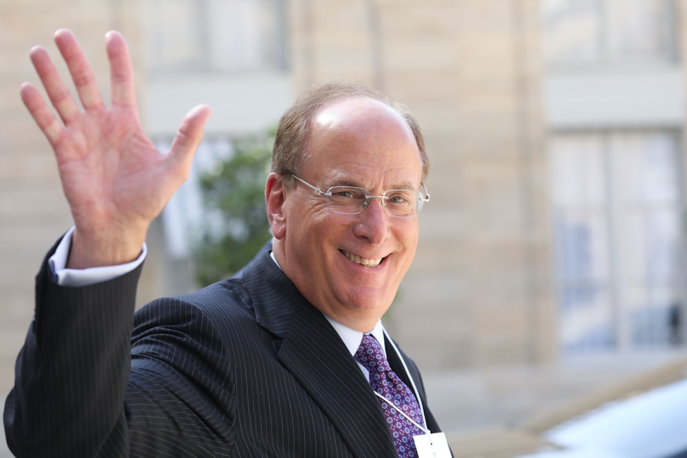BlackRock CEO Larry Fink smiles and waves.