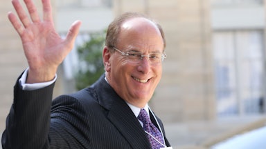BlackRock CEO Larry Fink smiles and waves.