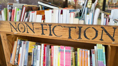 cart of books with a sign reading "non-fiction"