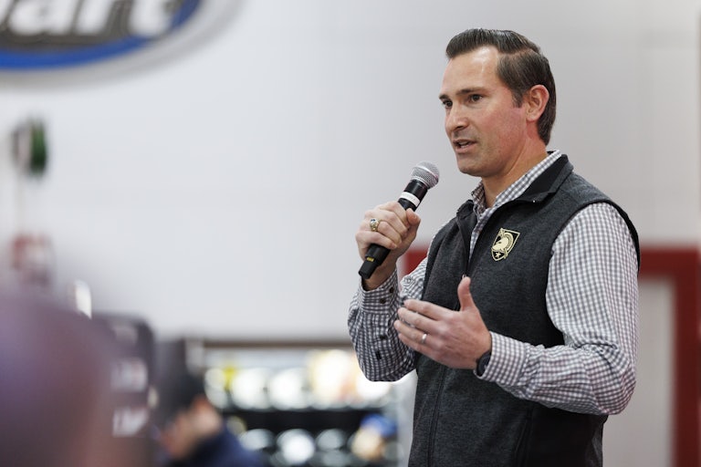 Matt Van Epps holds a microphone and speaks into it during a campaign event