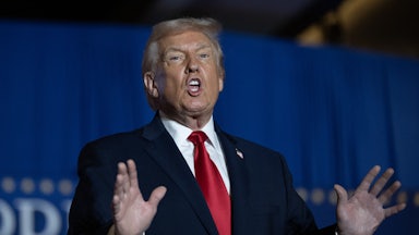 Donald Trump speaks at a reception, using his hands.