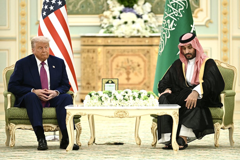 Donald Trump sits next to Saudi Crown Prince Mohammed bin Salman