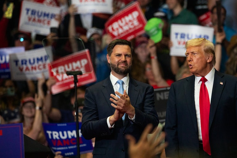J.D. Vance and Donald Trump stand next to each other at a campaign rally