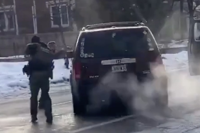 an ICE officer fires into the drivers side window of a SUV