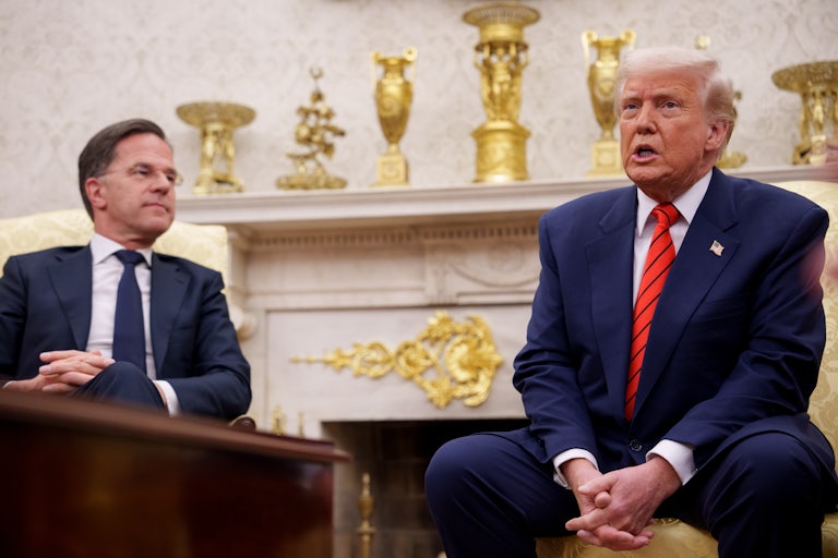NATO Secretary General Mark Rutte watches Donald Trump speak as they sit in the Oval Office