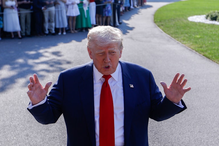 Donald Trump gestures while speaking to reporters outside the White House