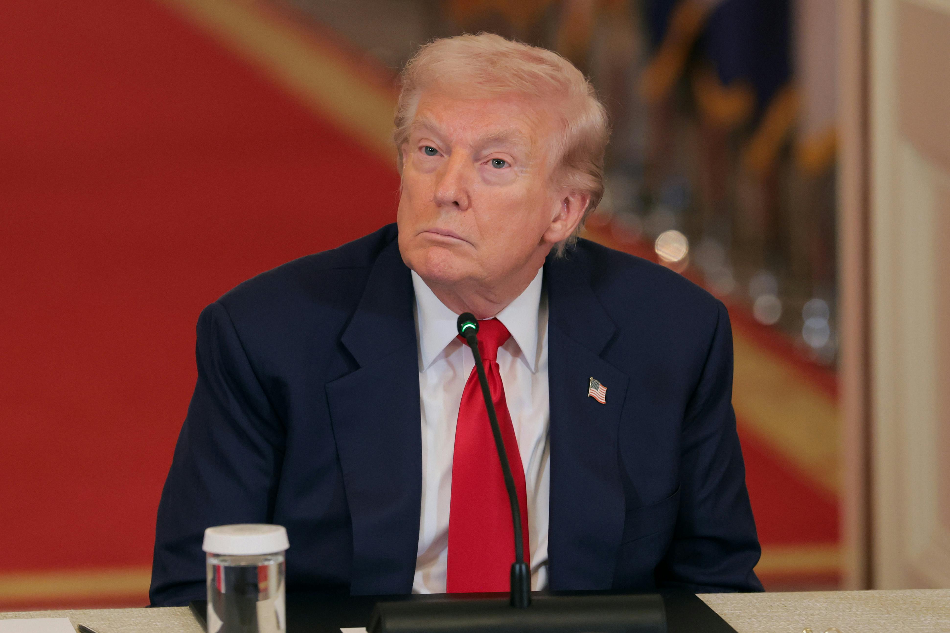 Donald Trump stares blankly while sitting