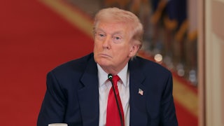 Donald Trump stares blankly while sitting